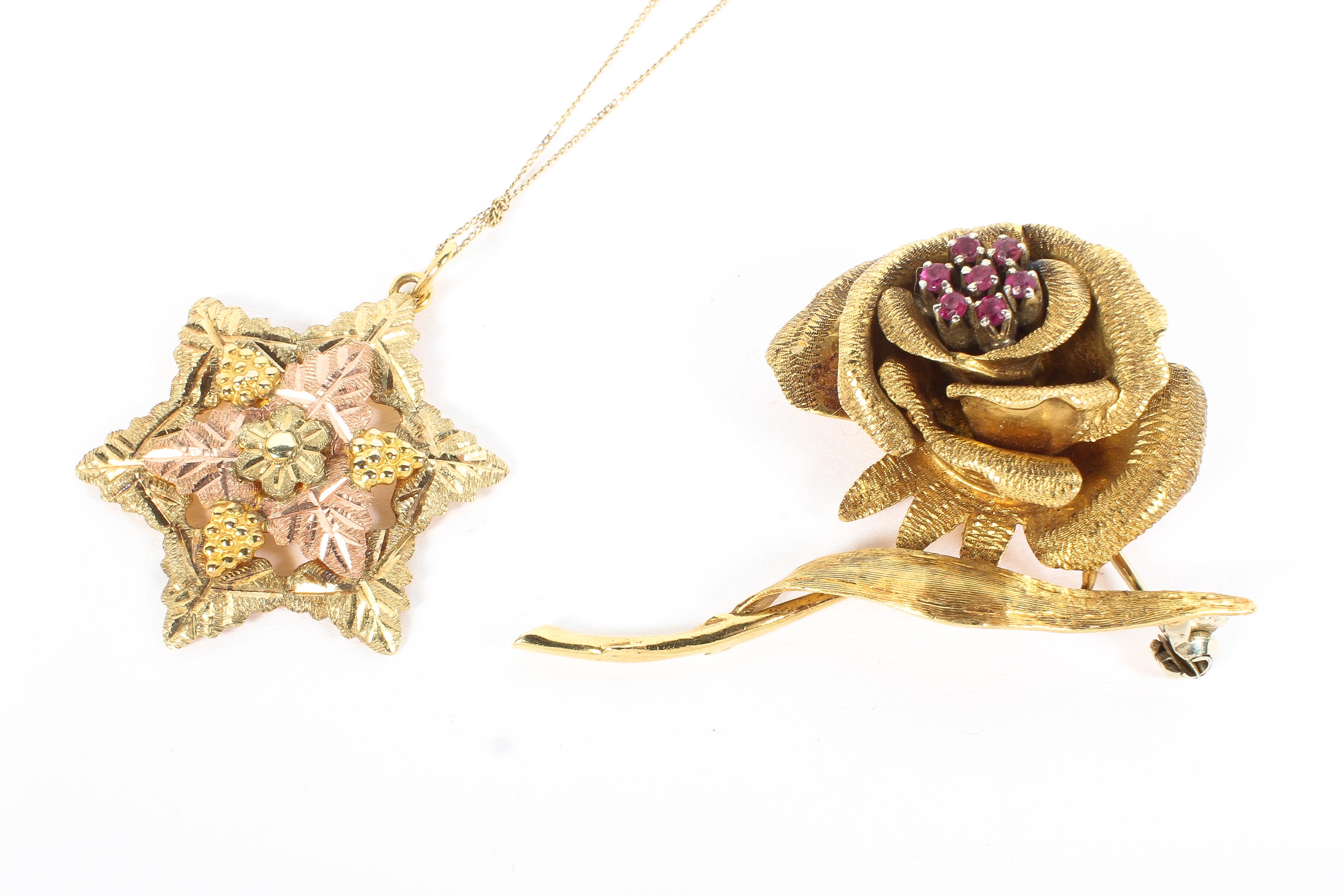 An 18ct gold flower brooch, modelled as a rose, set with rubies to the centre, 12g, - Image 2 of 2