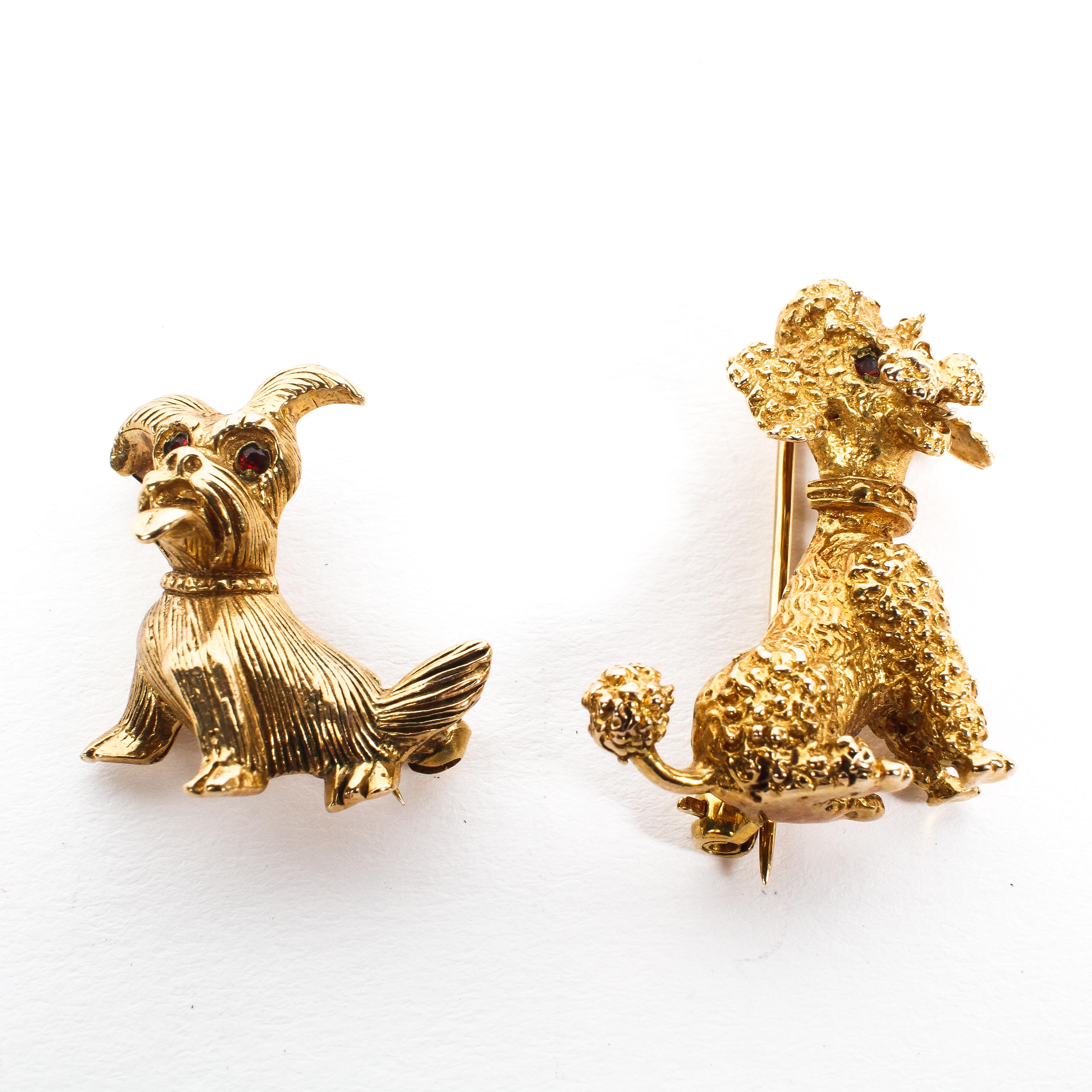 Two 9ct yellow gold brooches each modelled as a seated dog, one a poodle, the other a terrier,