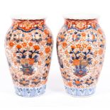 A pair of Japanese Imari vases, early 20th century, of tapered ovoid form with fluted rims,
