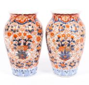 A pair of Japanese Imari vases, early 20th century, of tapered ovoid form with fluted rims,