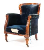 A Victorian mahogany upholstered tub chair without swept arms and spring seat raised on turned