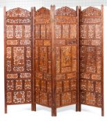 A Indian hardwood for fold screen with pierced panels and all over carved decoration 182cm height