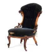 A Victorian mahogany button backed bedroom chair with pierced carved decoration to the wings,