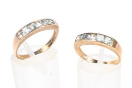 Two 9ct gold and aquamarine half eternity rings, each set with a line of princess cut aquamarines,