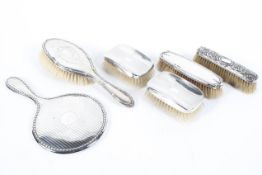 A collection of silver dressing table wares, to include gentlemans clothes brushes,