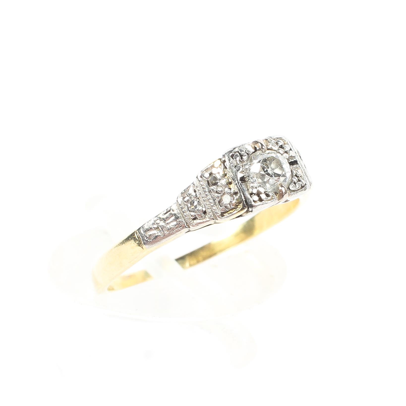 An unmarked yellow and white metal diamond set ring.