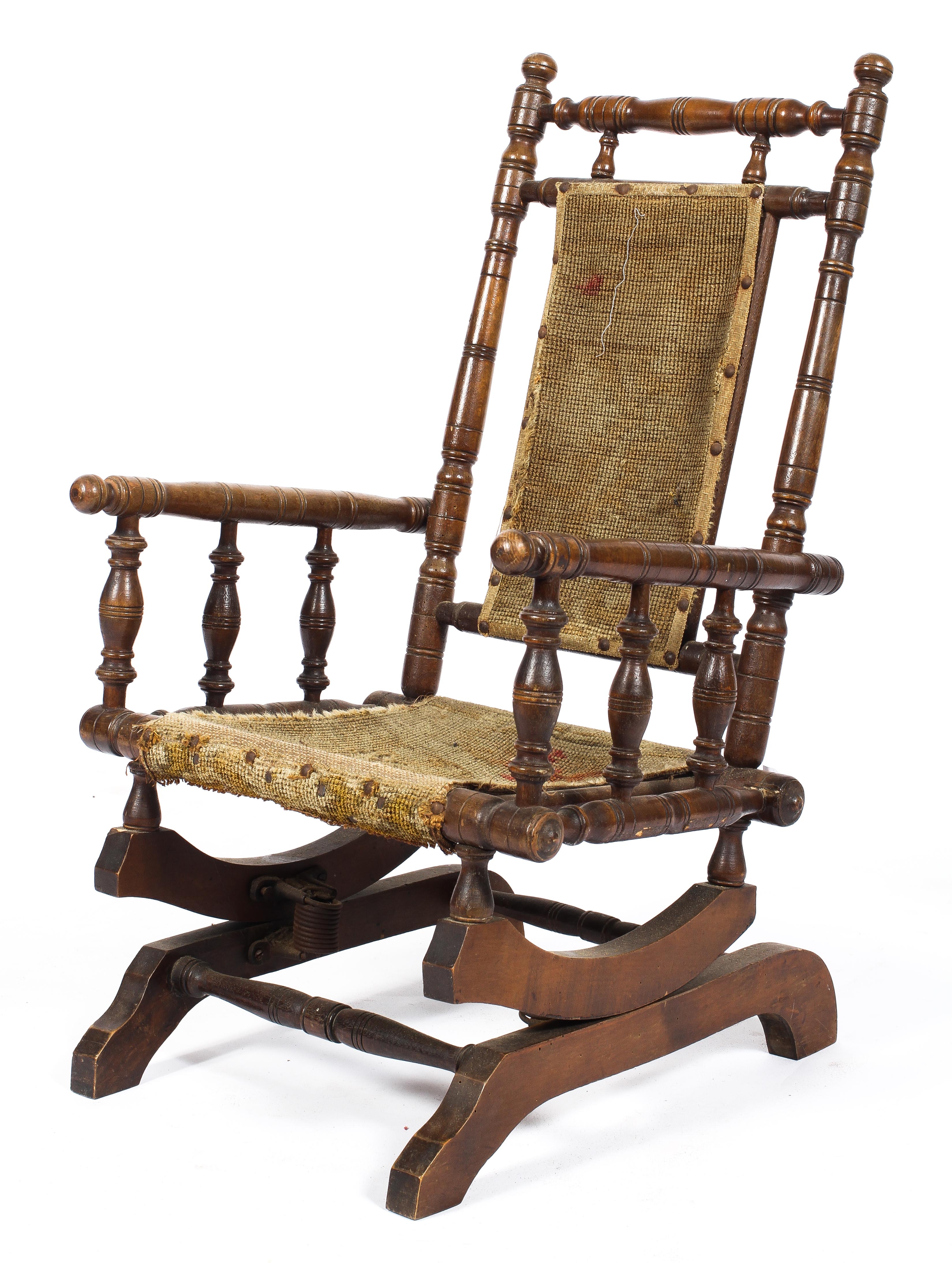 An Edwardian oak child's rocking chair, with turned reeded spindles and uprights,