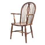A Windsor oak and elm armchair of wheelback design