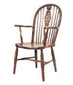 A Windsor oak and elm armchair of wheelback design