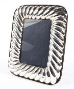 A vintage silver picture frame, with rounded corners and reeded design, hallmarked London 1988,