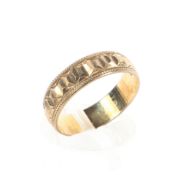 A 9ct gold wedding band with bead work and engraved decoration, Size l 2.