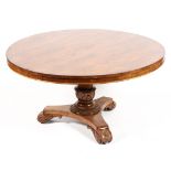 A Victorian rosewood round tilt topped breakfast table raised on carved tulip ballester shaped