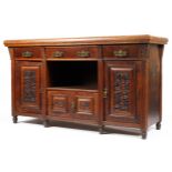 A 20th century teak sideboard of large formation with three drawers above an open well and a small