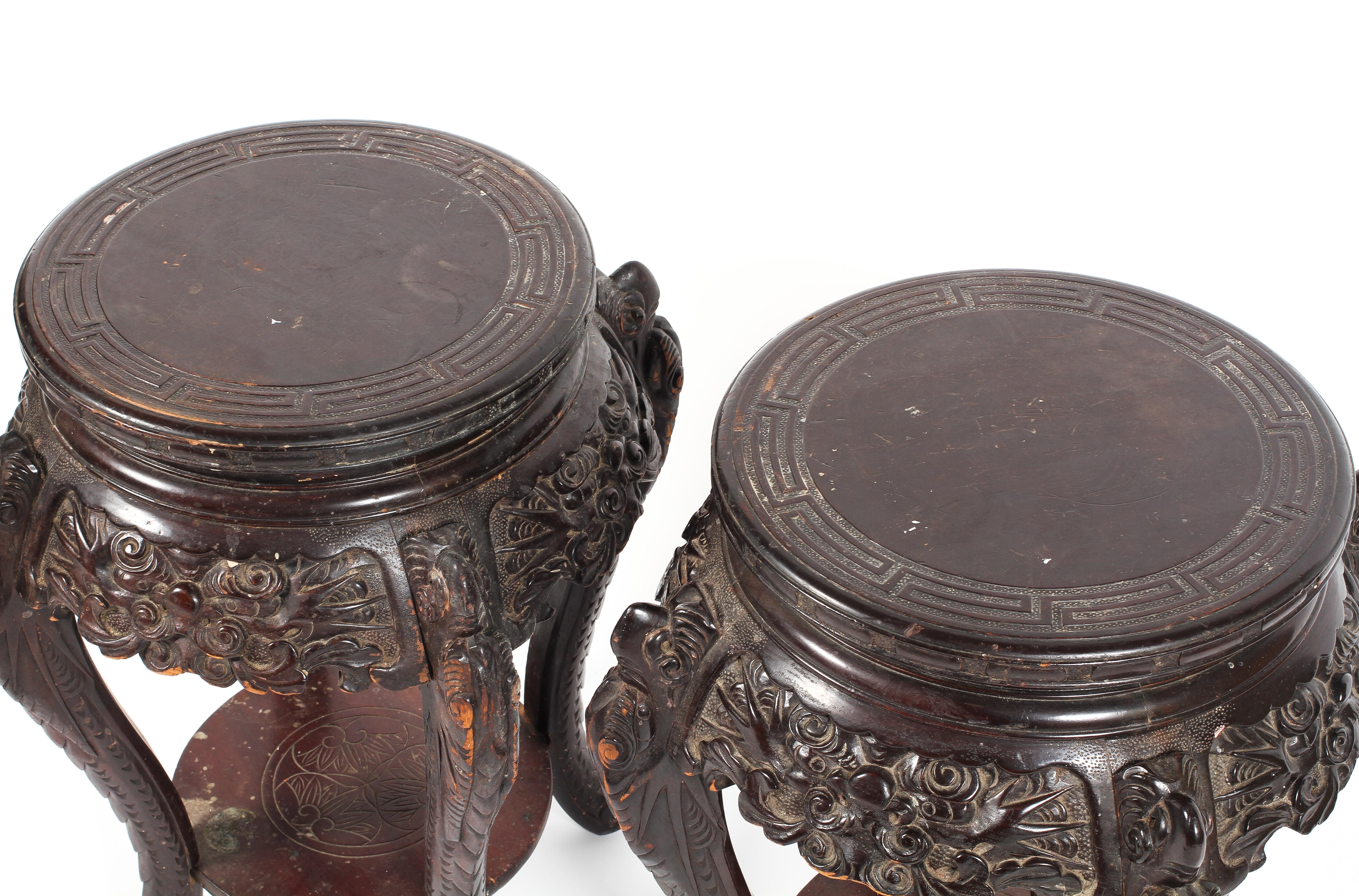 A pair of early 20th century Chinese carved lamp tables with under tier raised on carved cabroile - Image 2 of 2