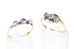 An 18ct gold and diamond three stone ring together with a 9ct ruby ring with diamond accents,