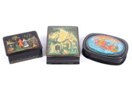 Three Russian lacquered boxes one decorated with troika, the others with figural scenes.