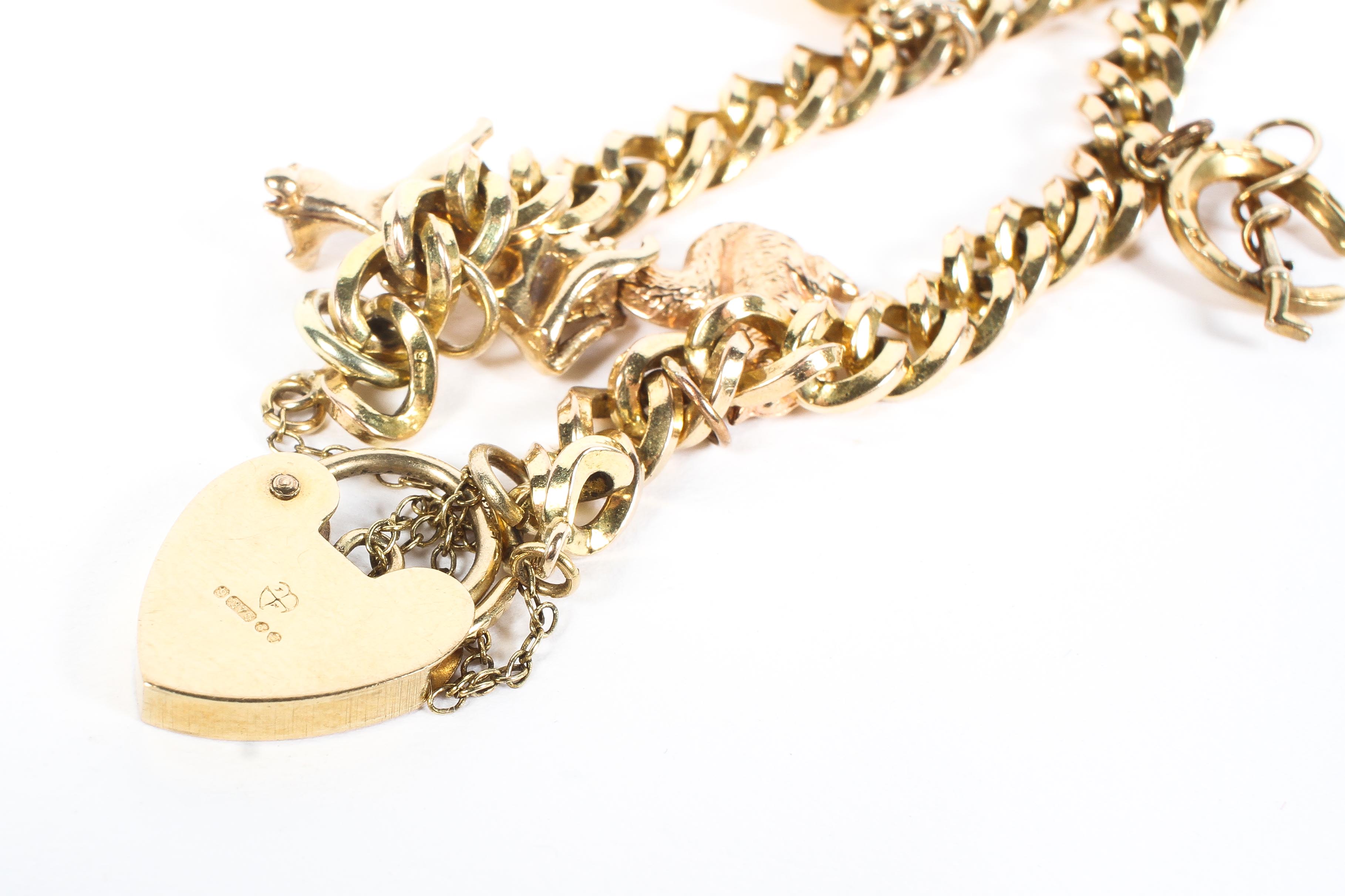 A 9ct gold charm bracelet, with safety lock and chain and five assorted charms attached, 17. - Image 2 of 2