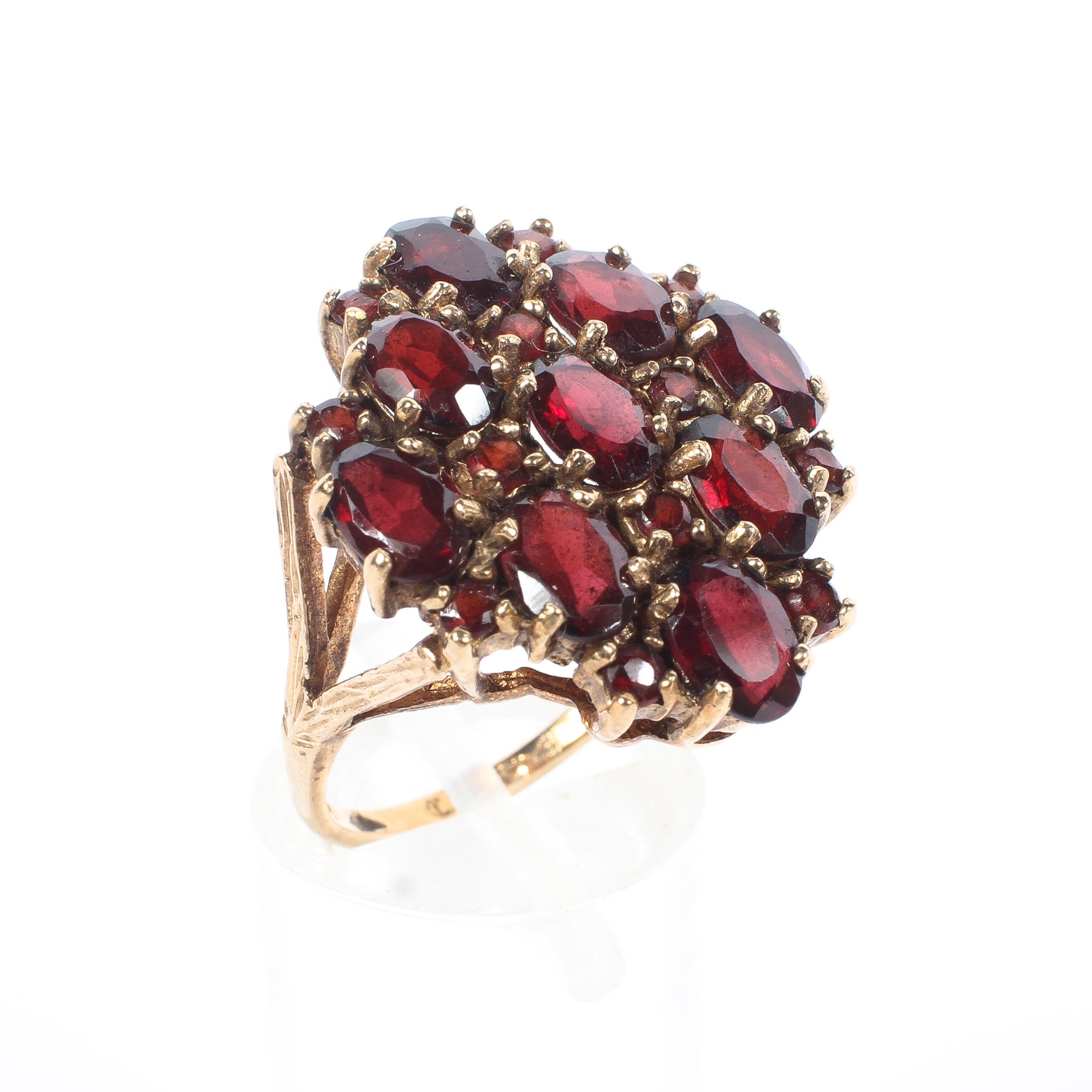 A 9ct gold nine stone garnet dress ring, size N, 6.