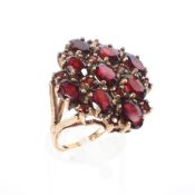 A 9ct gold nine stone garnet dress ring, size N, 6.