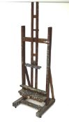 A 19th century English oak artist easel with fully working winding handle to adjust height by local