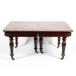 A Victorian mahogany dining table each section with three reeded tulip carved supports to castors