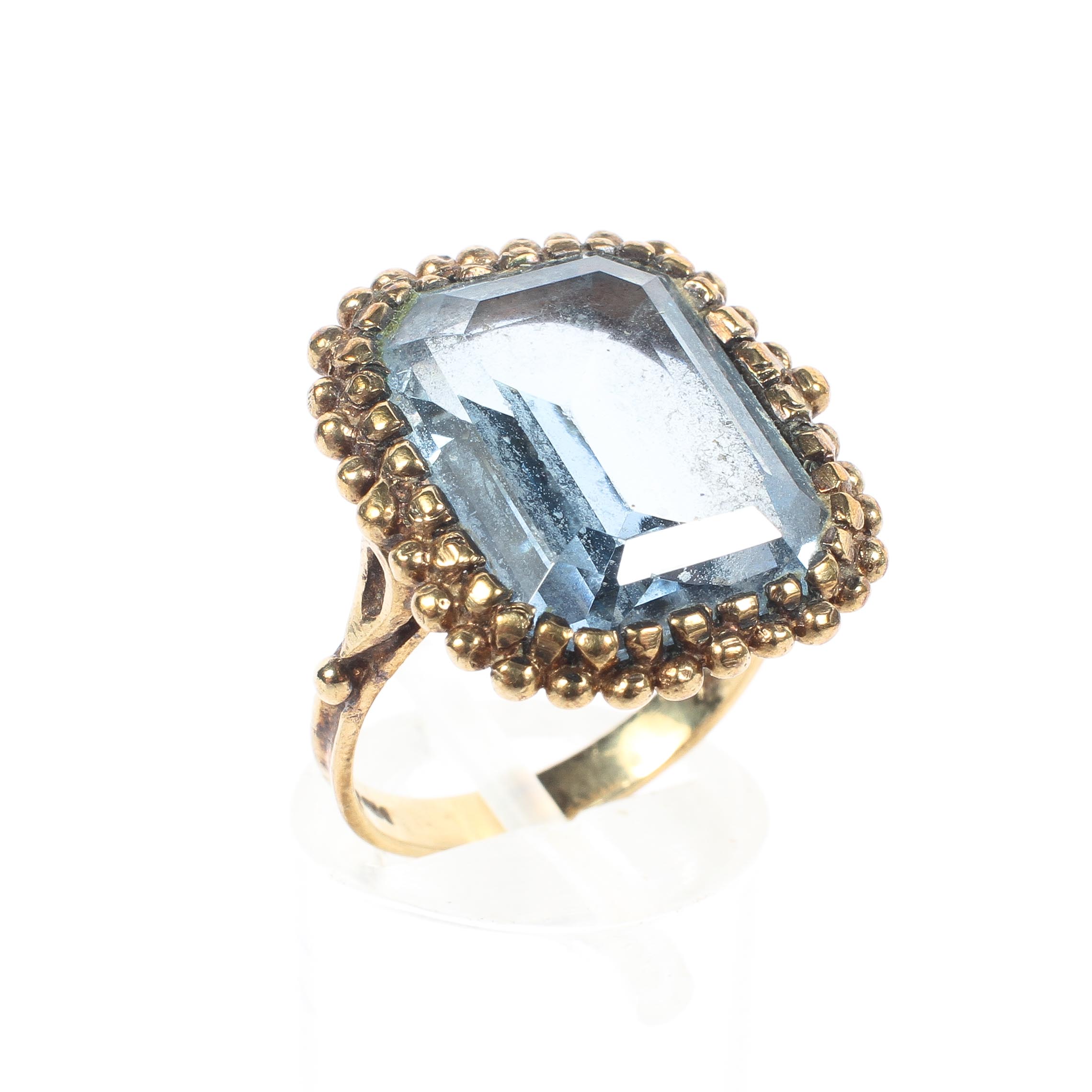 A 9ct rose gold and aquamarine ring, the single emerald cut aquamarine 15mm x 13mm,