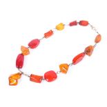A harlequin amber necklace, the clasp marked 375, 34g. Overall length 44cm.