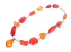 A harlequin amber necklace, the clasp marked 375, 34g. Overall length 44cm.