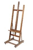 An oak framed artists easel on castors 52cm wide x 150cm height Condition Report: