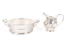 A silver mounted butter dish and a small British import silver cream jug,