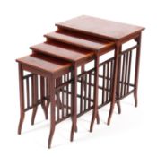 An Edwardian Quarterto nest of four inlaid mahogany tables raised on slender out swept supports and