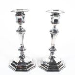A pair of mid century silver candlesticks, each of octagonal form,