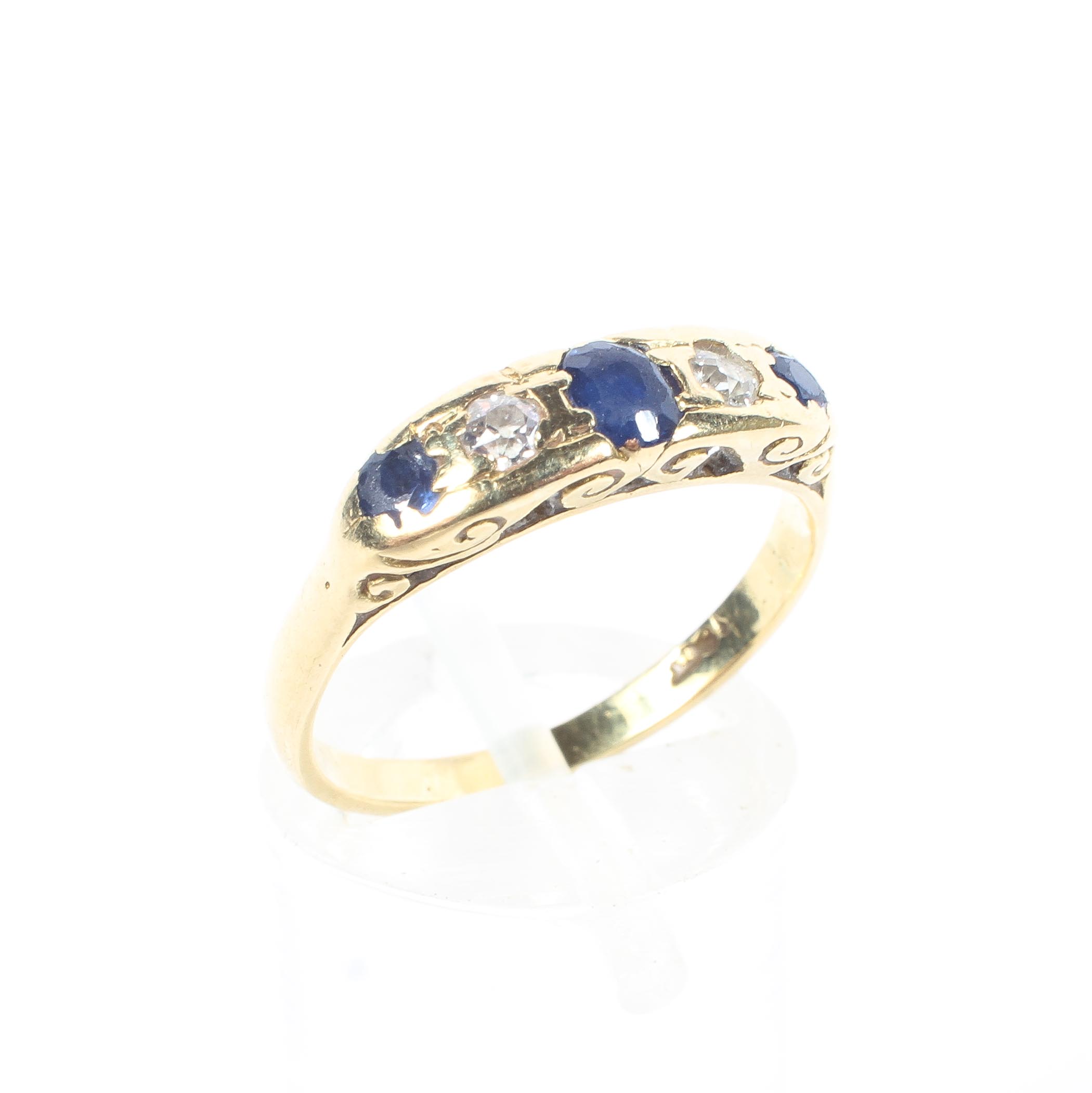 An 18ct yellow gold sapphire and diamond five stone ring, with pierced shank, stamped 18k, 3.