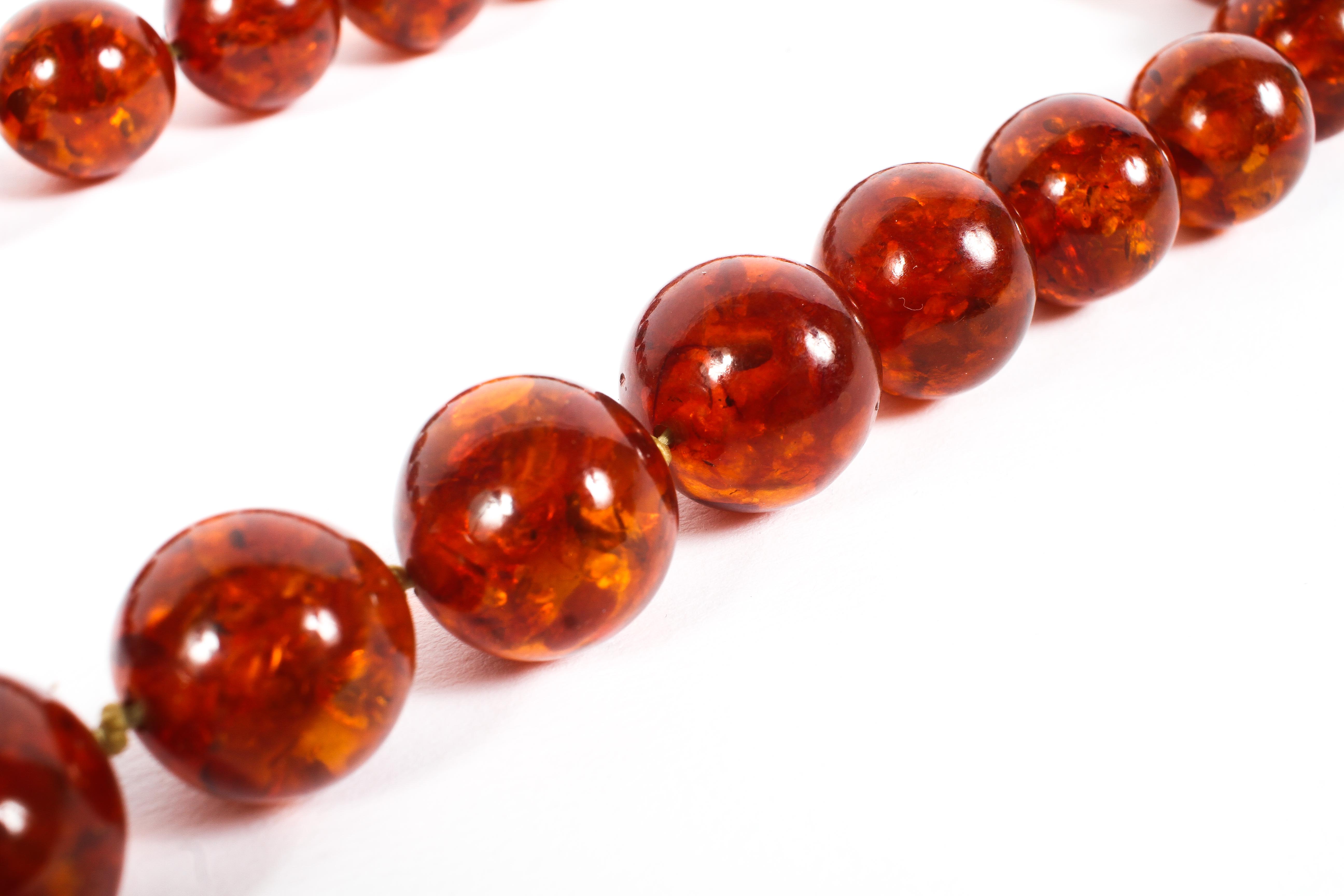 A faux amber necklace, uniform strand of circular beads. - Image 2 of 2