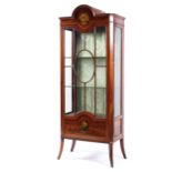 An Edwardian painted Sheraton style glazed display cabinet with arched pediment,