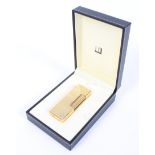 A gold plated Dunhill Rollagas lighter in original box.