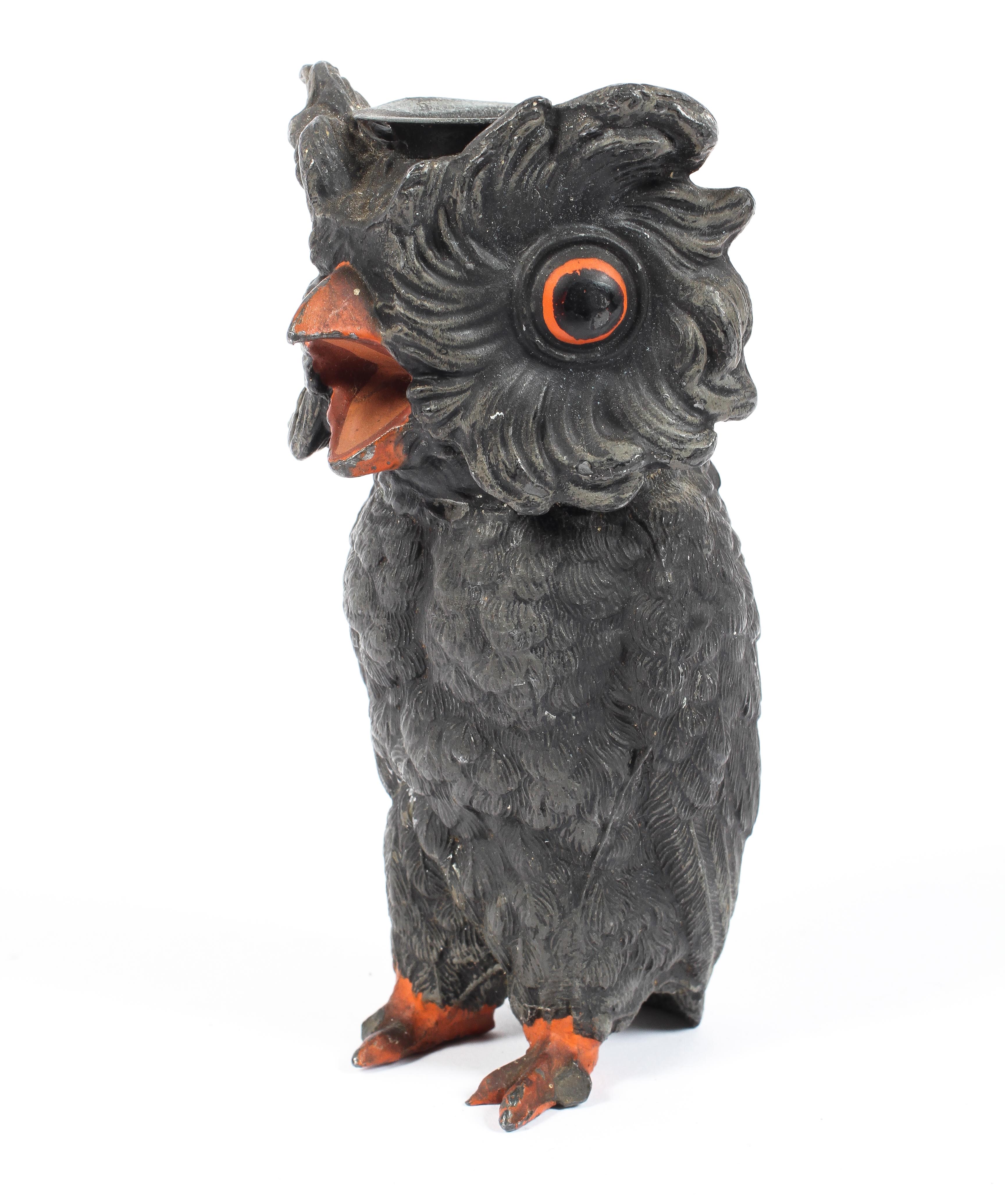 A cast metal cold painted candlestick modelled as an owl, late 19th century/early 20th century,