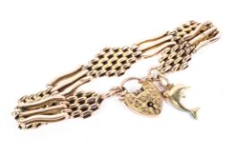 A 9ct gold gateleg bracelet with heart locket,