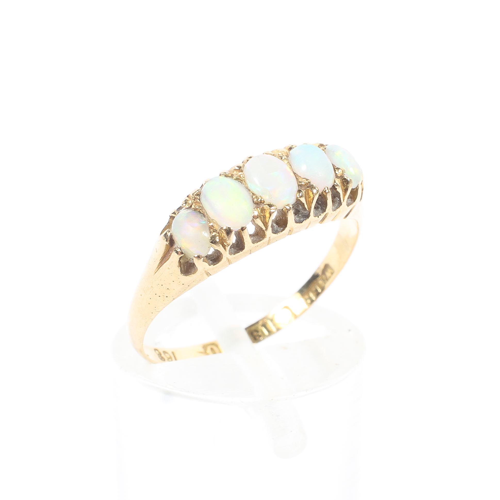 An 18ct gold five stone opal dress ring, draws colour, featuring five graduated stones, 2.