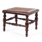 An Edwardian mahogany cane work topped footstool raised on turned supports and stretchers of small