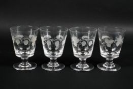 Four antique glasses engraved with hops and barley on a footed base 14cm high