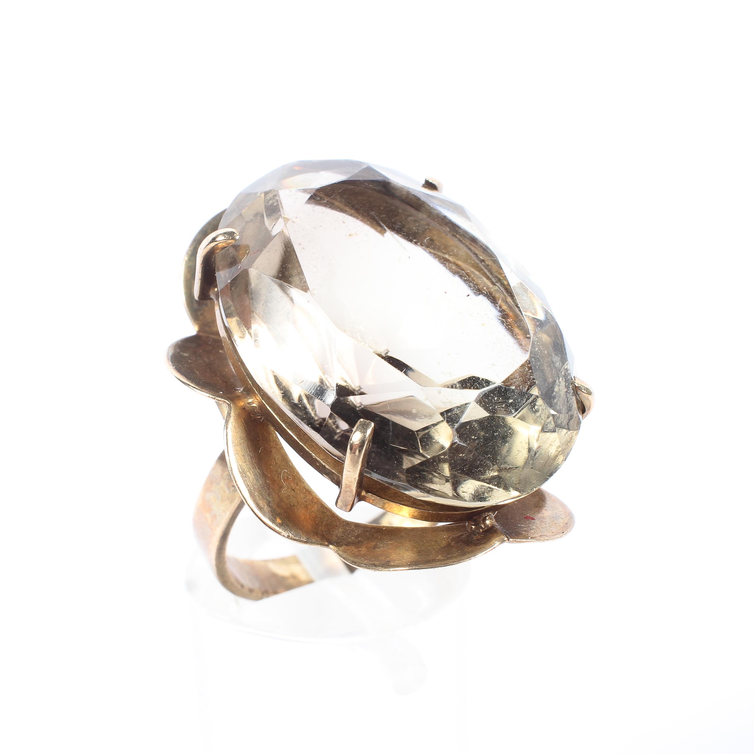 A 9ct gold and smoky quartz dress ring, set with oval free cut quartz to an open work setting, 9.