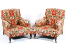 A pair of 20th century Howard style lounge chairs on square tapered legs roll over arm & swept side