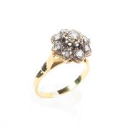 An 18ct gold and diamond cluster ring, set with nine brilliant cut diamonds, central stone approx 0.