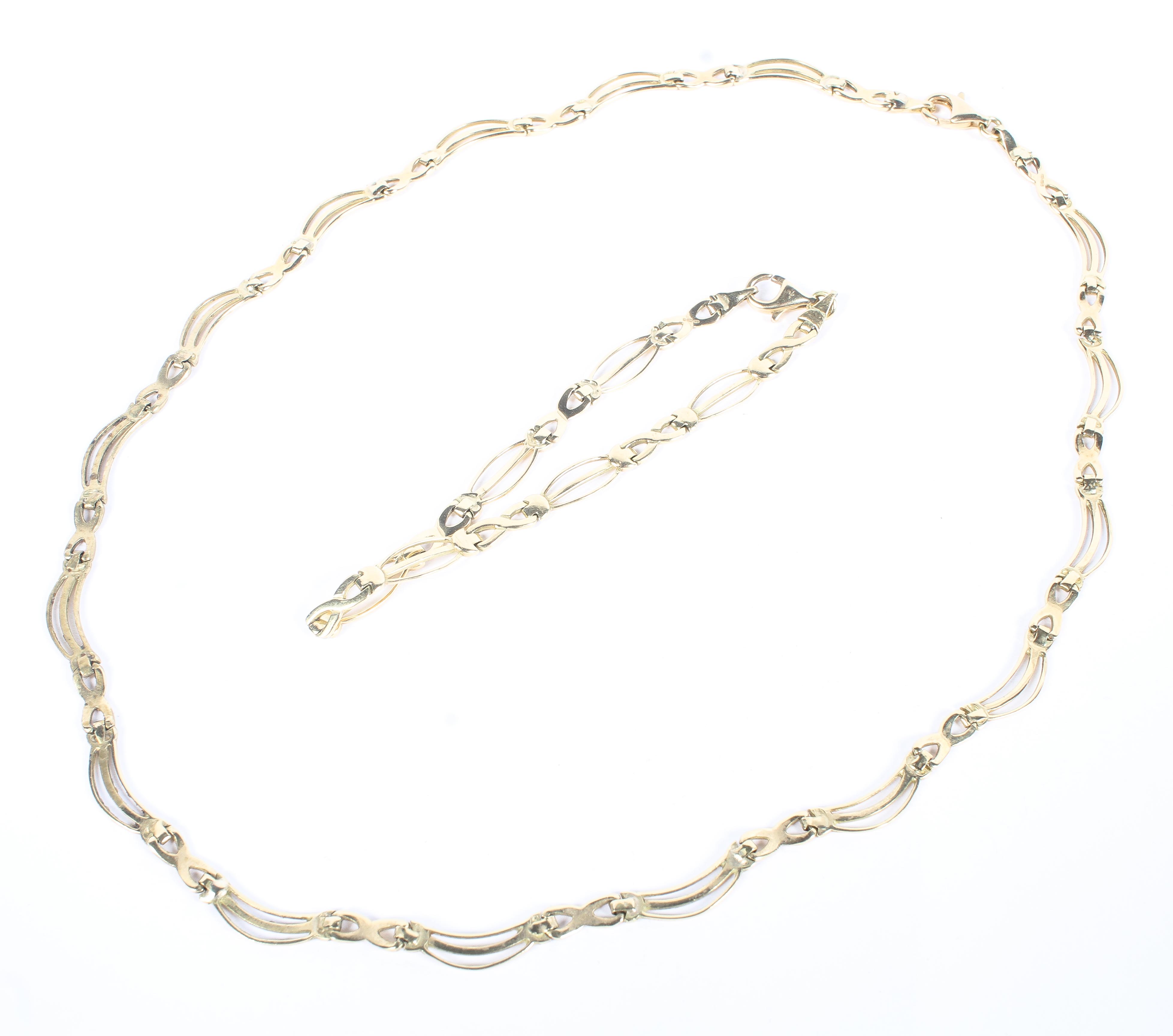 An 18ct gold flat fancy link necklace together with matching bracelet..43cm and 18cm. 25g.