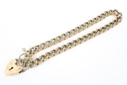 A 9ct gold curb link bracelet with 9ct gold heart locket. 18cm. 15g.