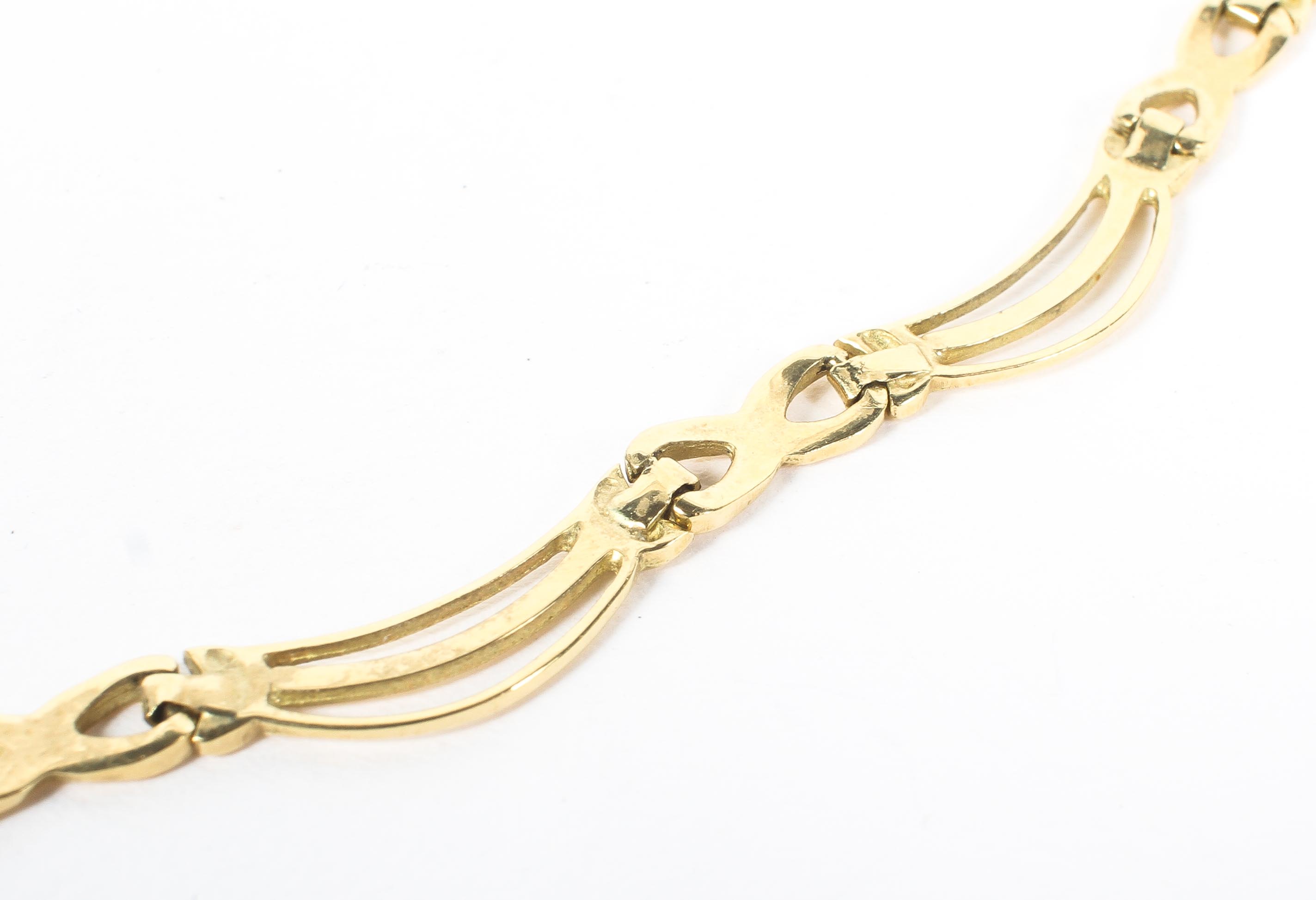 An 18ct gold flat fancy link necklace together with matching bracelet..43cm and 18cm. 25g. - Image 2 of 3