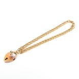 A child's 9ct gold curb link bracelet with heart locket clasp, 3.