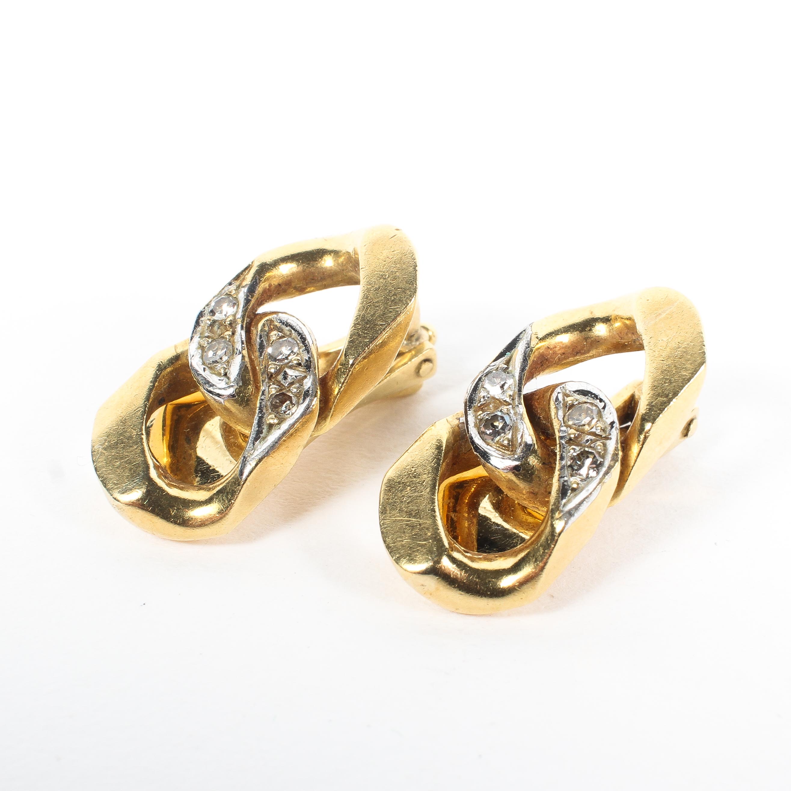 A pair of 18ct gold and diamond ear clip earrings, in the form of two curb links,