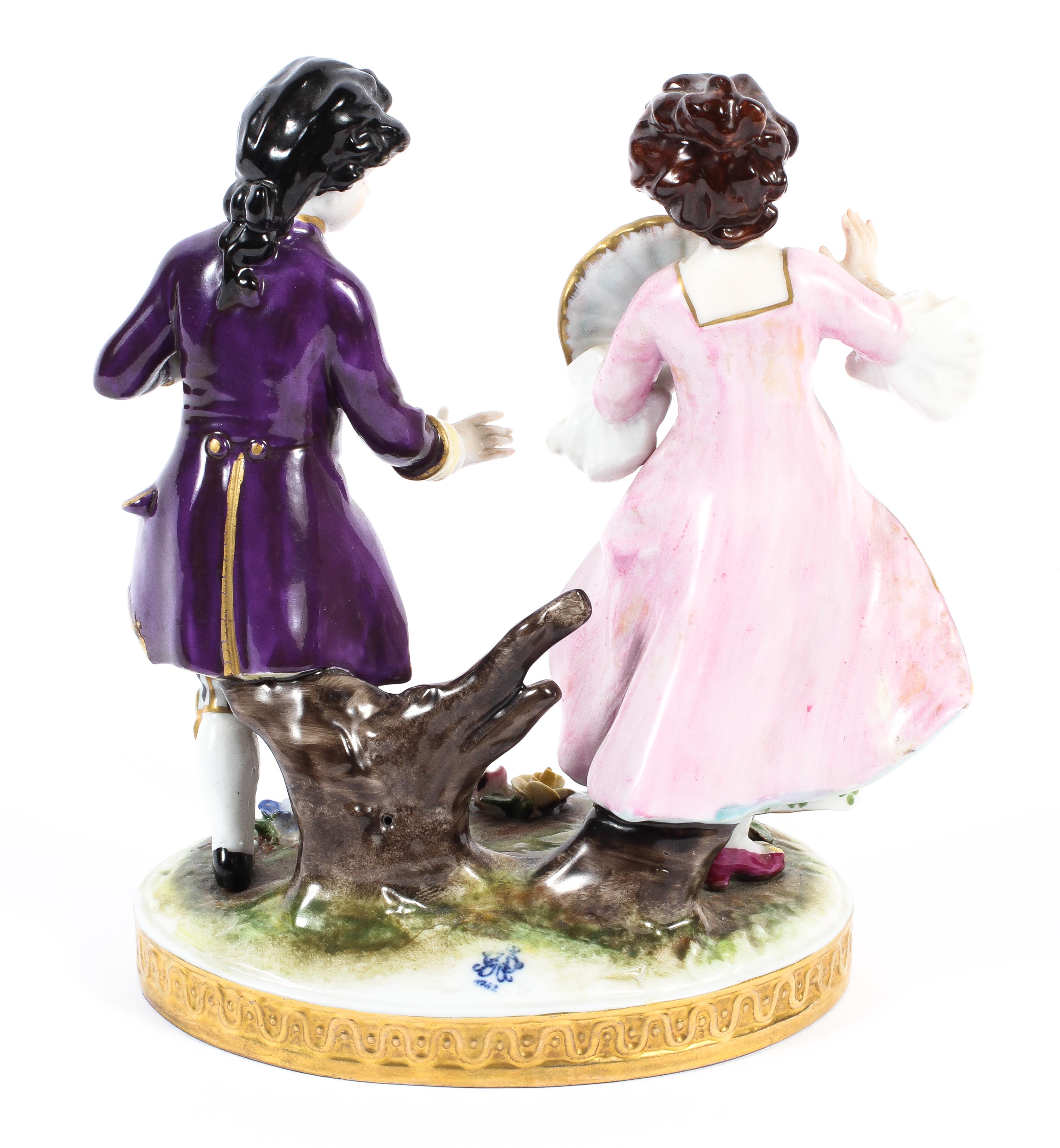 A continental porcelain figural group of a lady with fan in pink and a gentleman in purple jacket. - Image 2 of 2